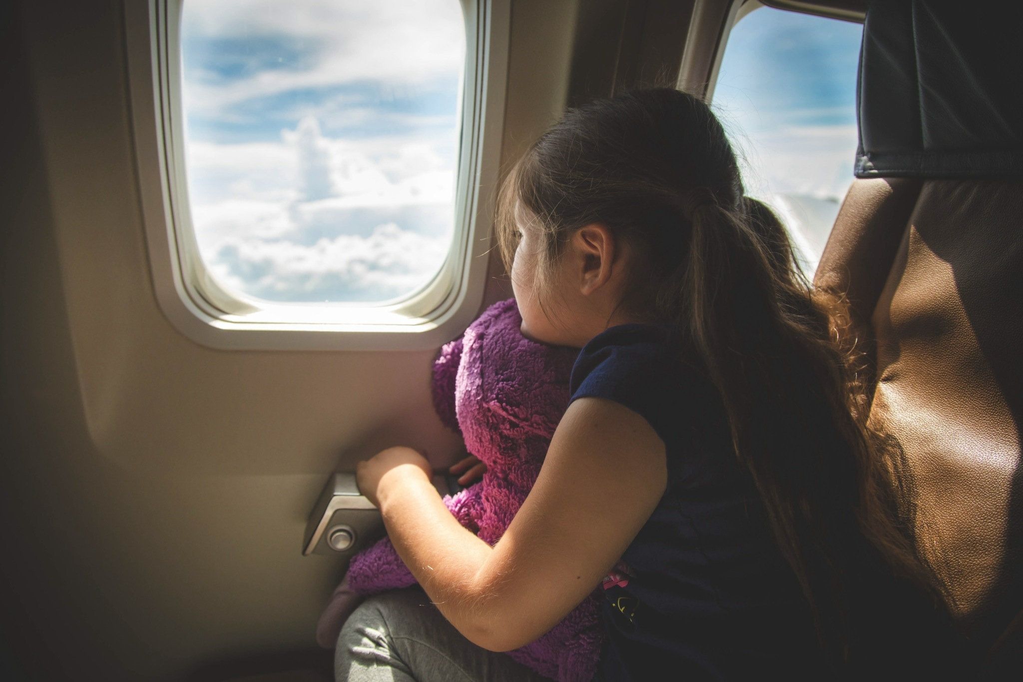 child looking out an air plane window