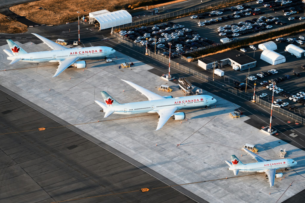 three large Air Canada airplanes parked at airport