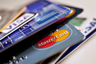 American Express, MasterCard and Visa credit cards are displayed for a photograph in New York, U.S., on Tuesday, May 18, 2010. Credit-card firms caught off-guard by U.S. Senate passage of curbs on debit fees are facing what one executive sees as a "volcanic" eruption of legislation, including possible limits on interest rates. Photographer: Daniel Acker/Bloomberg